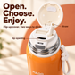 Close-up of the orange FULOO bottle's open inner lid, with labeled flip-up straw and separate oval sip opening.