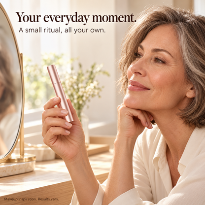 Mature woman with rose-gold mascara in a warm morning vanity setting