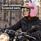 Woman wearing the Pink motorcycle helmet with ears covered and chin strap secured on a parked motorcycle.