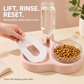 A hand lifting the white oval drinking cover from the pink water tray for cleaning